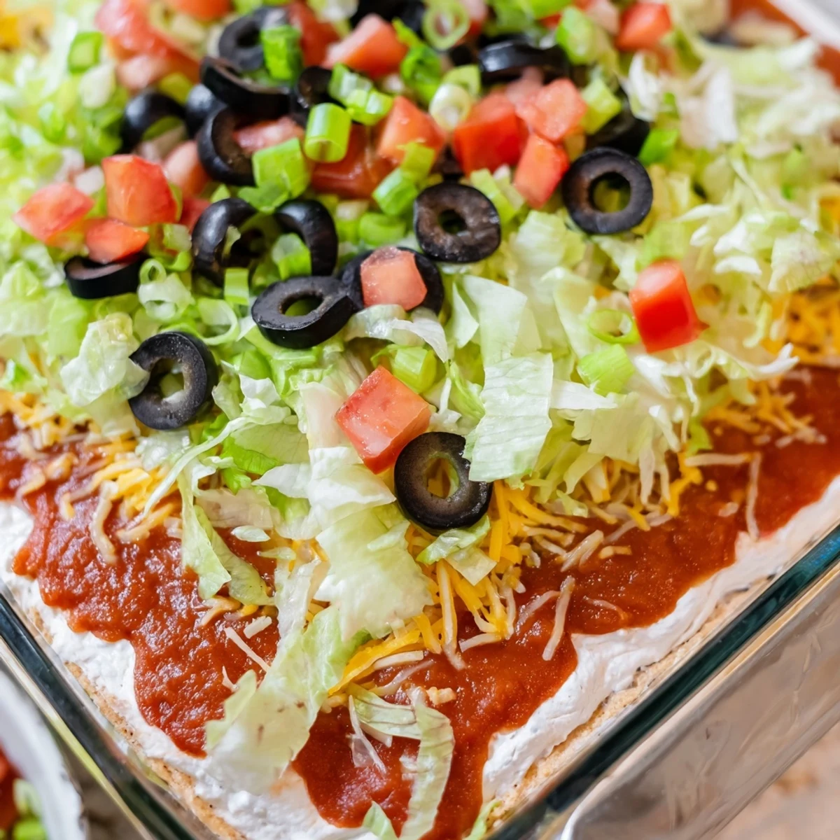 Crowds will love this chilled Tex-Mex Super Bowl Seven Layer Taco Dip, served with a side of crunchy tortilla chips.