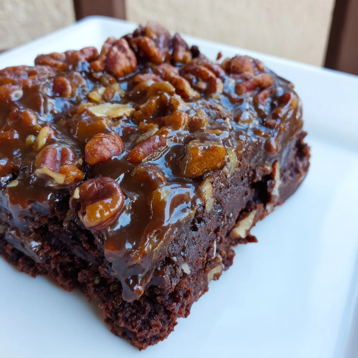 Sliced squares of New Orleans Praline Brownies, revealing a fudgy interior and crunchy toasted pecans on top.