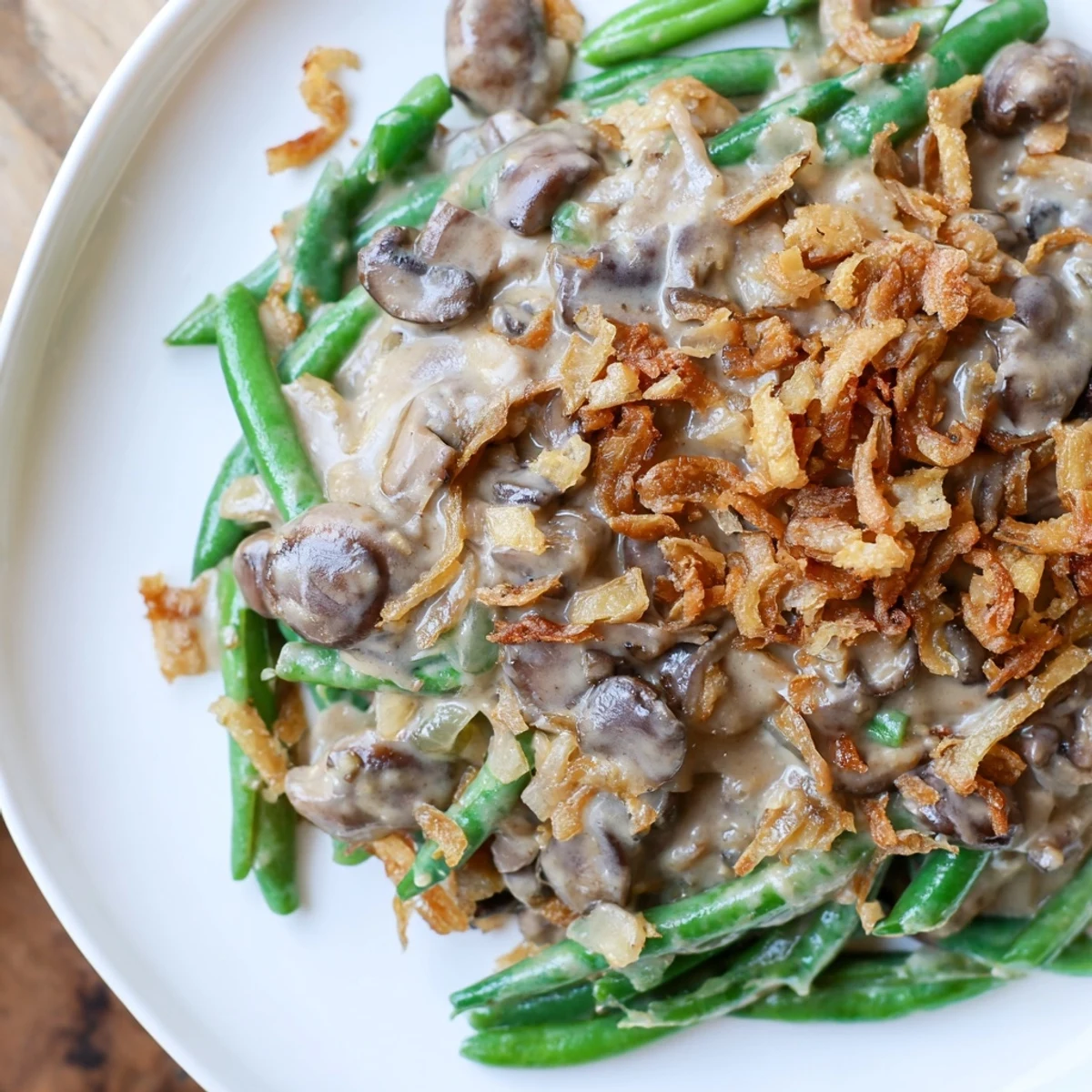 A close-up of Green Bean Casserole with Crispy Onions bubbling in a dish, golden brown and ready for a holiday table.