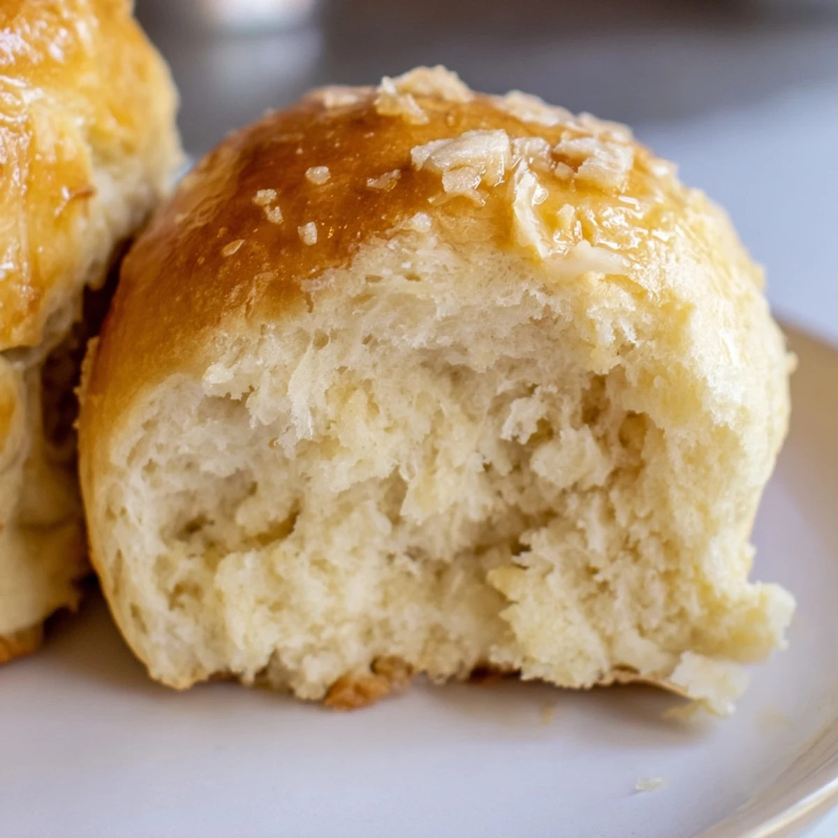 Homemade Best Vegan Dinner rolls with soft crumbs and a buttery aroma cooling on a wire rack.