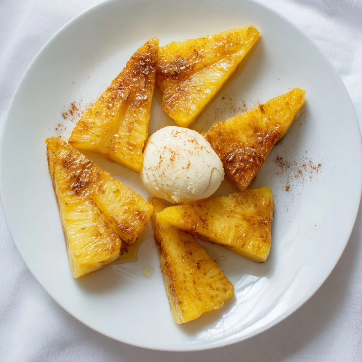 Juicy Rum-Soaked Fried Pineapple slices, coated in crispy batter and fried until golden, are drizzled with honey.