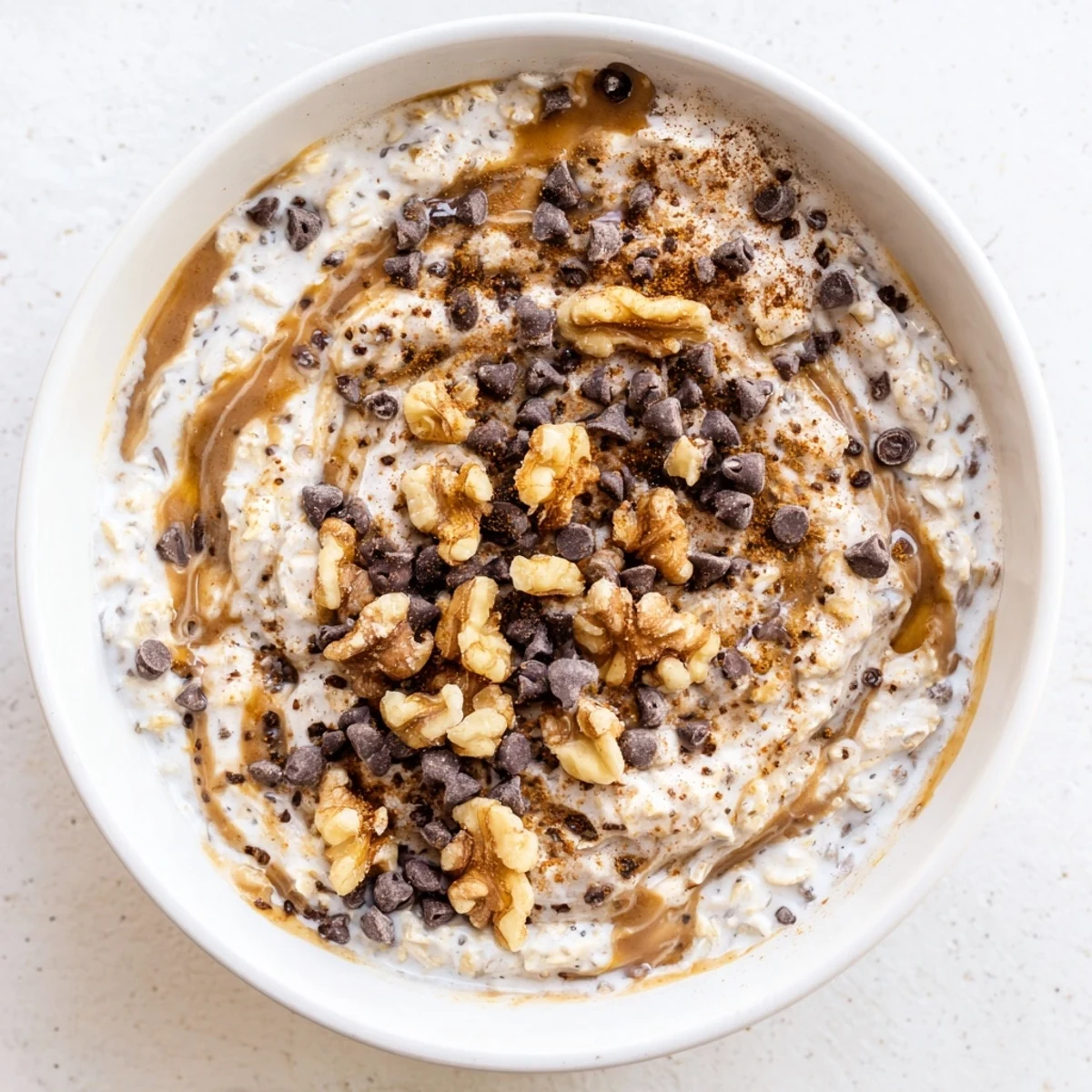 Morning serving of Cookie Dough Overnight Oats with rolled oats, chia seeds, and sweet maple syrup.