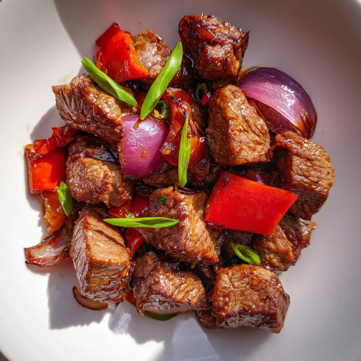 Vietnamese Shaking Beef served on a bed of fresh watercress and tomatoes with tangy lime sauce.