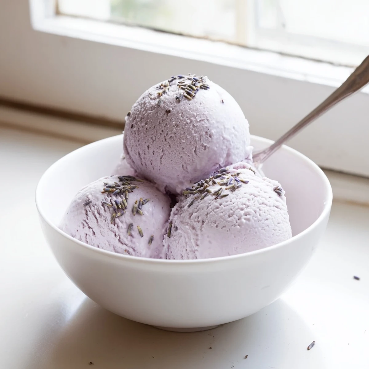 Lavender ice cream is churned to silky perfection in a homemade ice cream maker.
