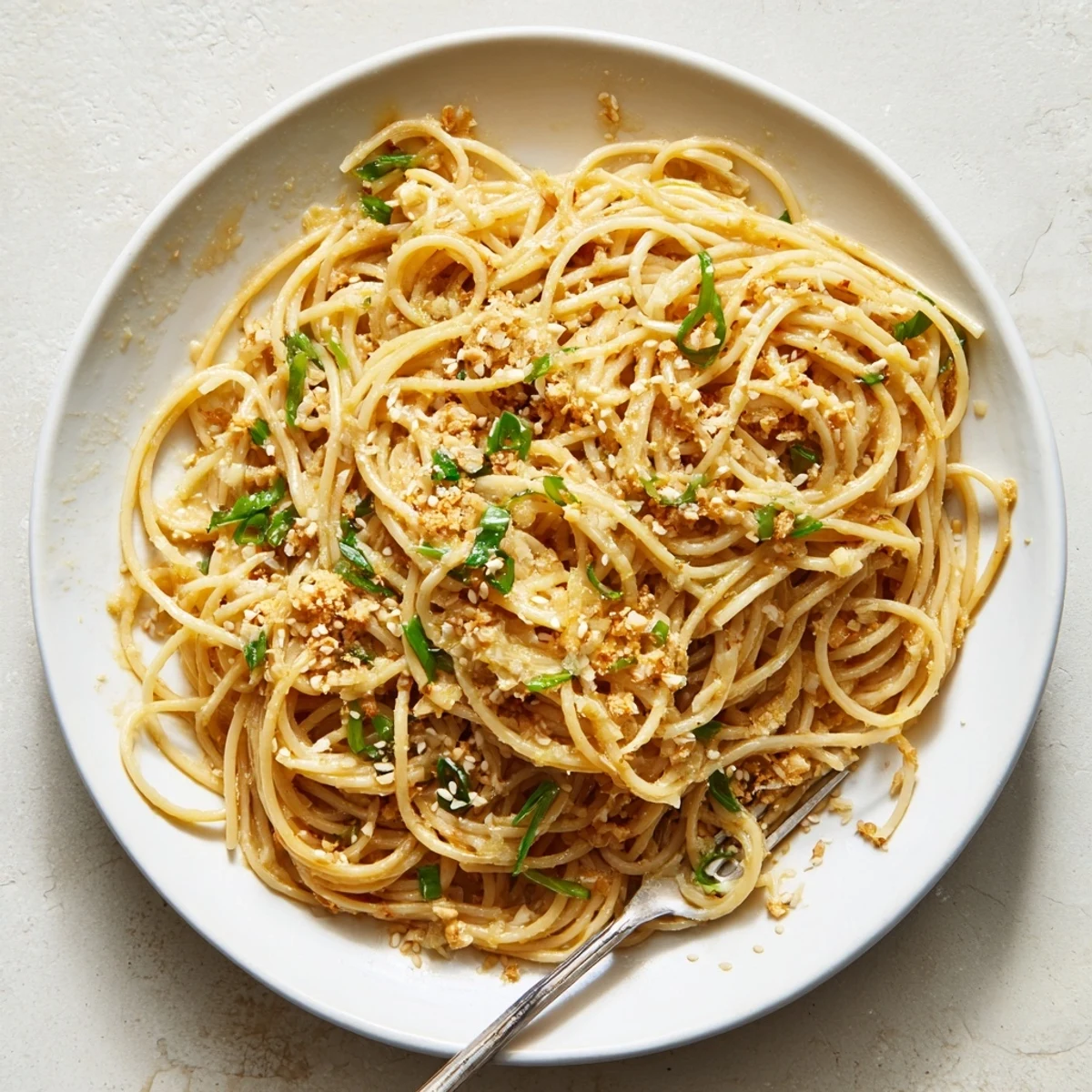 Steaming Garlic Noodles plated for a quick weeknight dinner, garnished with grated Parmesan and black pepper.
