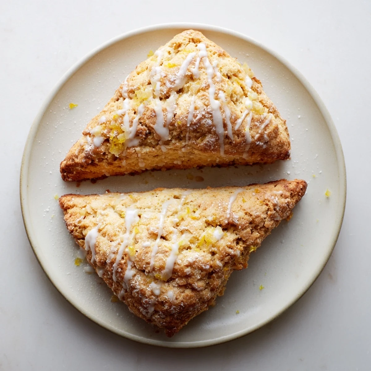 Warm Candied Ginger Orange Scones with visible bits of candied ginger and orange zest on a wooden cutting board.