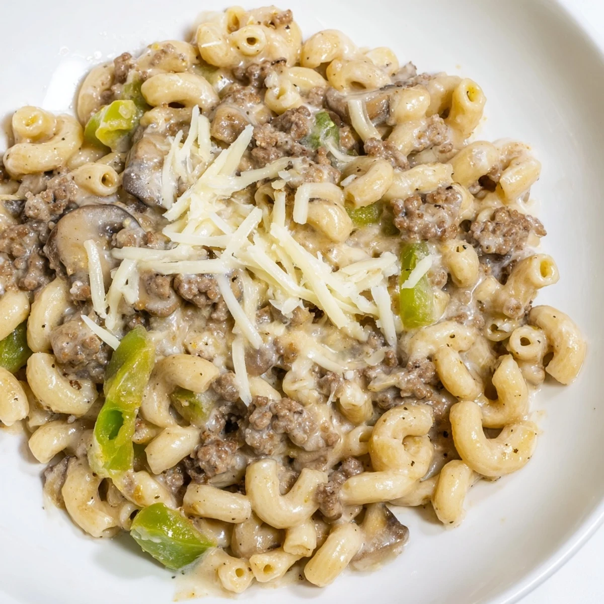 Close-up of Easy High Protein Philly Cheesesteak Mac in a skillet, showing creamy sauce and savory beef.