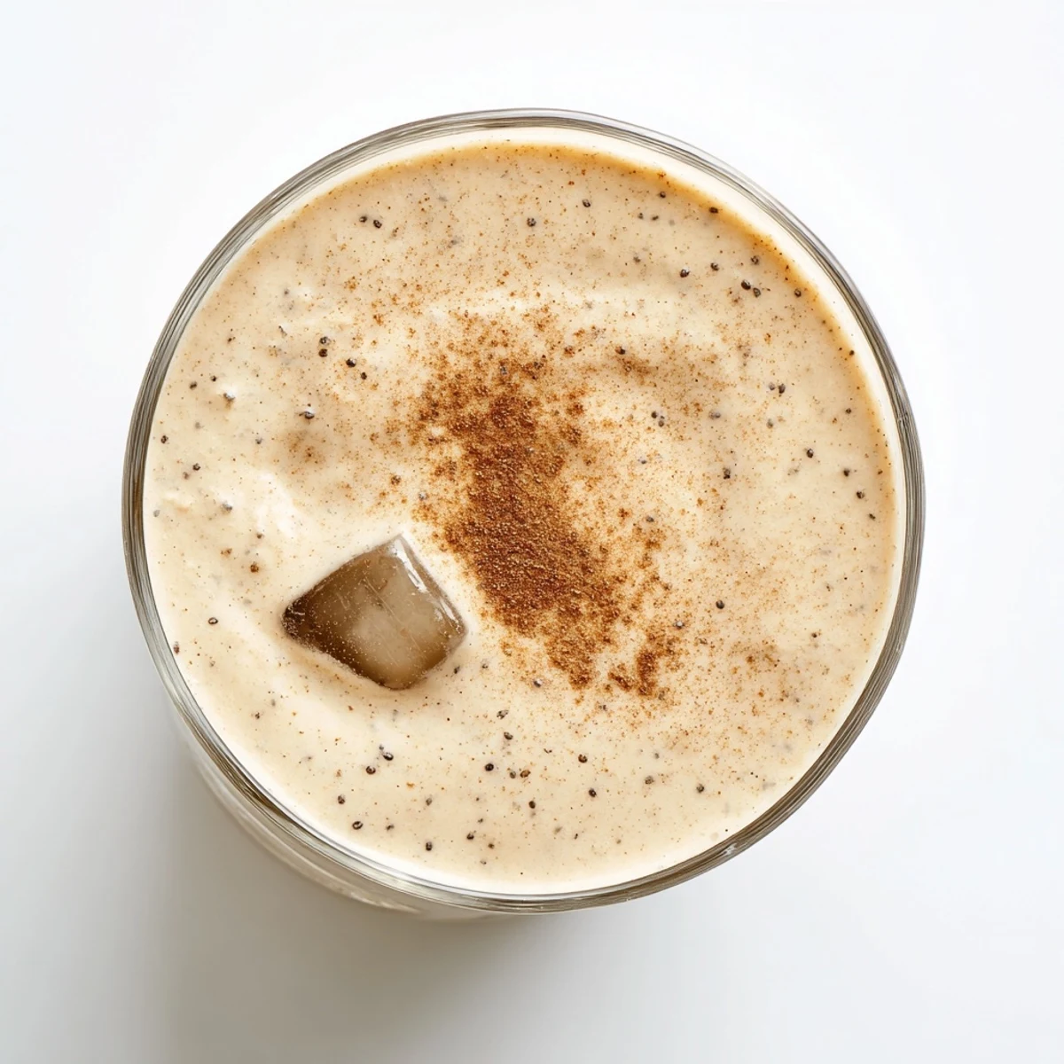 Protein-rich Greek yogurt banana smoothie in a tall glass with optional chia seed garnish