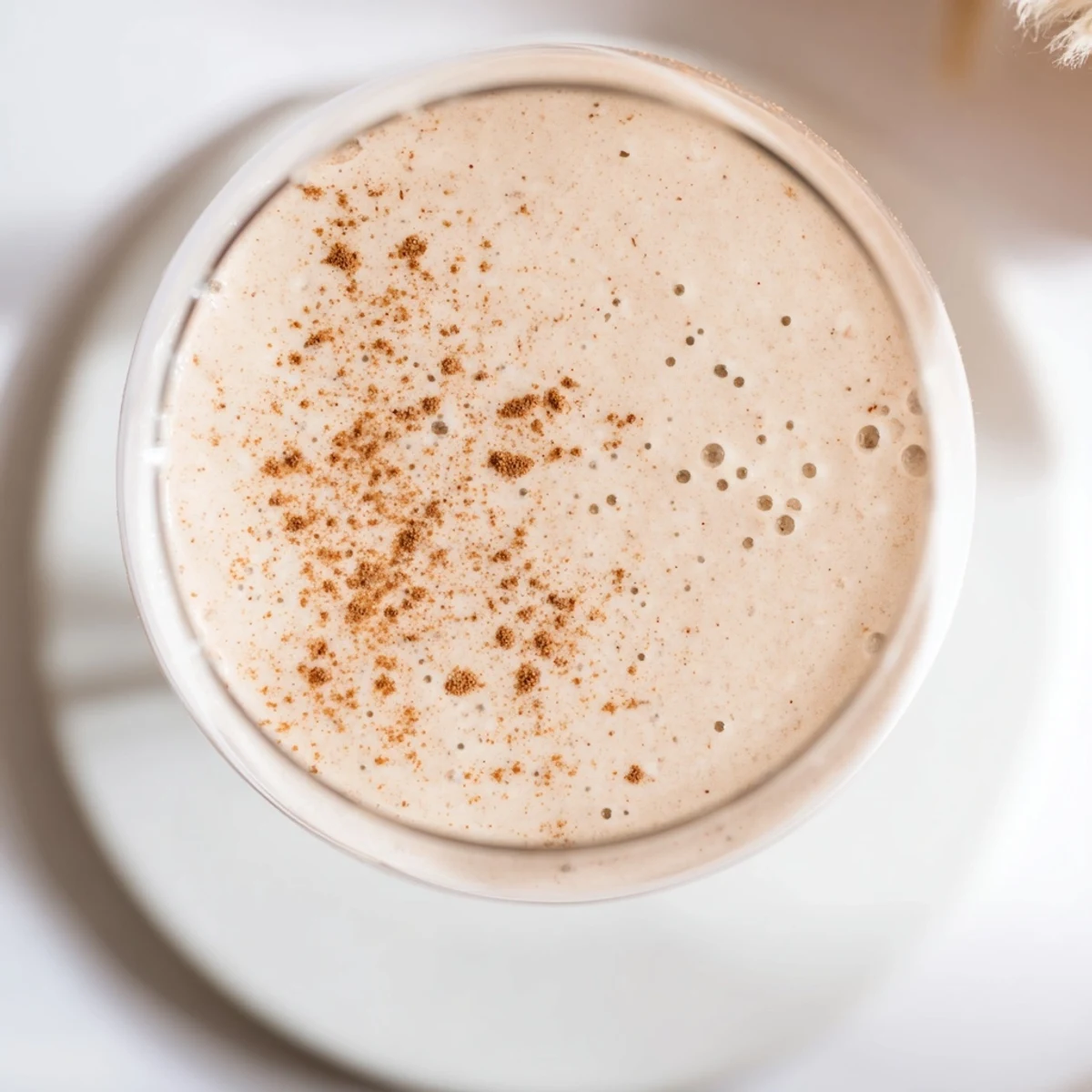 Thick protein-rich Greek yogurt banana smoothie blended with ice and drizzled with honey
