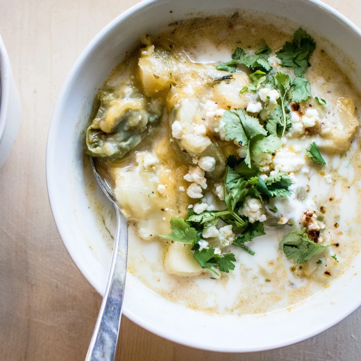 Steaming bowl of Chile Relleno Soup featuring melted Monterey Jack and roasted poblano peppers