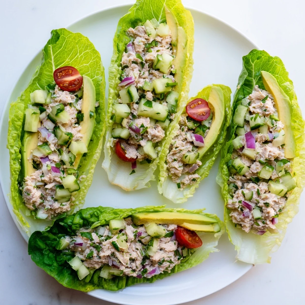 Crisp lettuce cups filled with zesty tuna salad, avocado slices, and cherry tomatoes