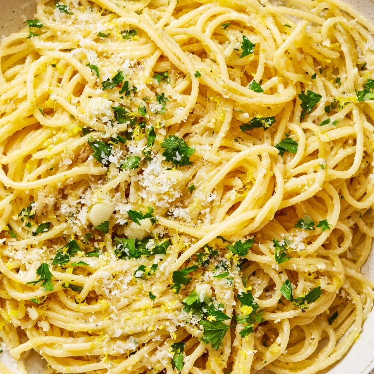 Golden strands of one pot garlic butter pasta coated in glossy Parmesan sauce with fresh parsley garnish