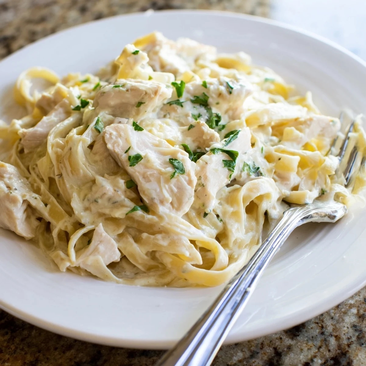 Creamy Instant Pot Chicken Alfredo with tender pasta pieces coated in rich parmesan garlic sauce