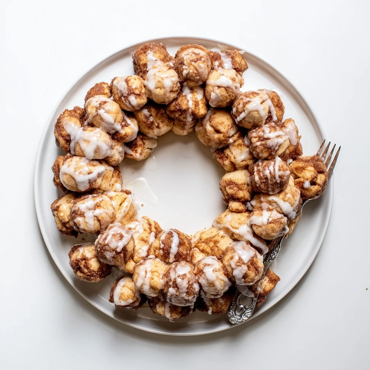 Fluffy dough balls of high protein no sugar monkey bread stacked with buttery cinnamon coating