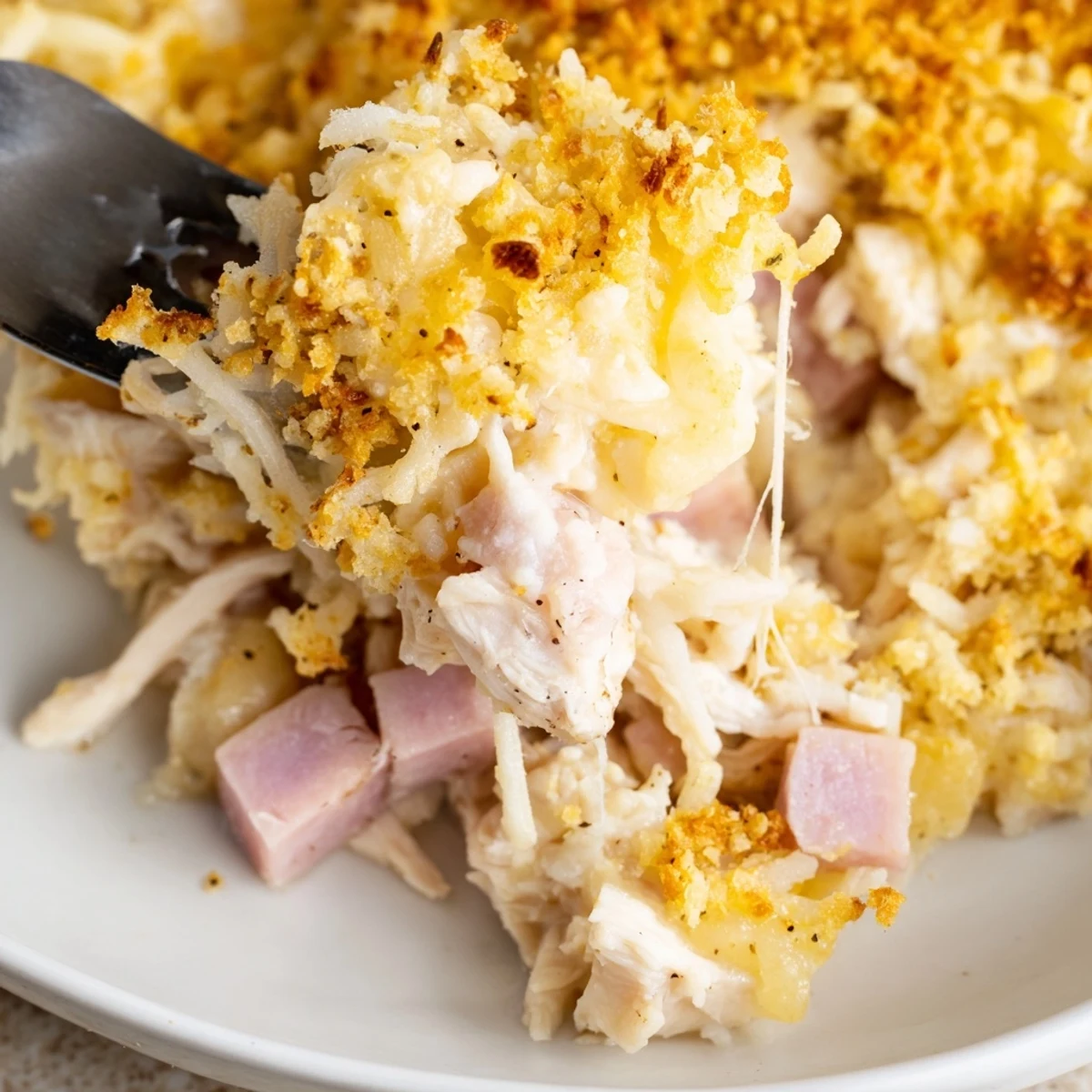 Golden bubbly Chicken Cordon Bleu Casserole with melted Swiss and crispy breadcrumb topping
