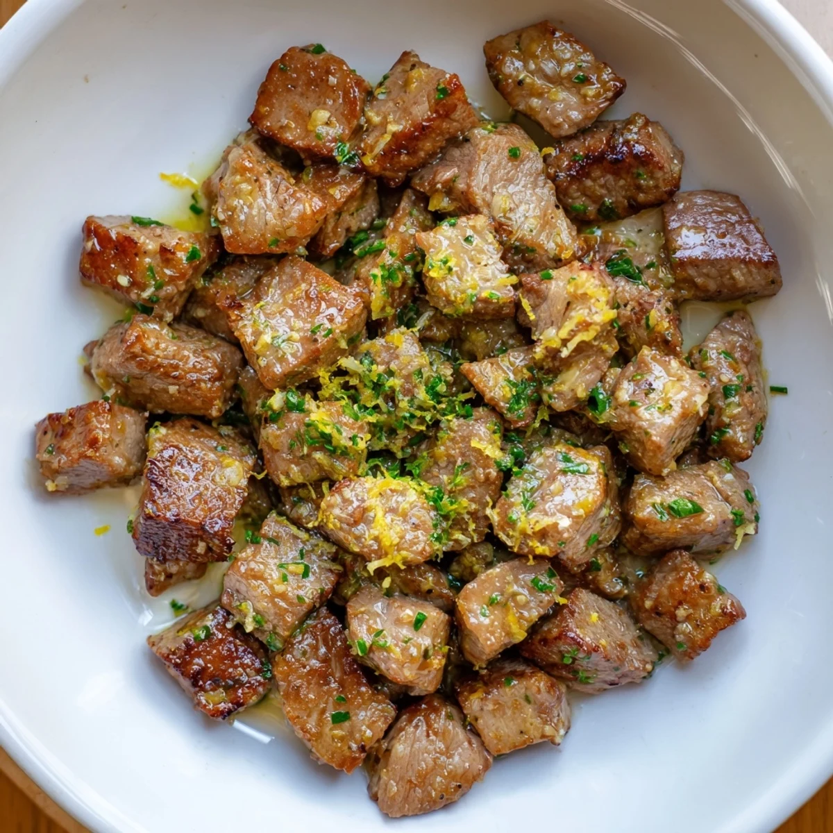 Garlicky Cowboy Butter Steak Bites piled on board, ready for sharing