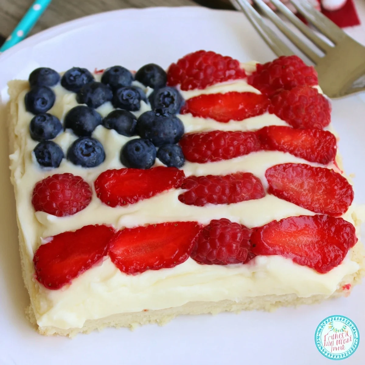 Baked Sugar Cookie Flag Fruit Pizza showing golden edges, juicy berries arranged