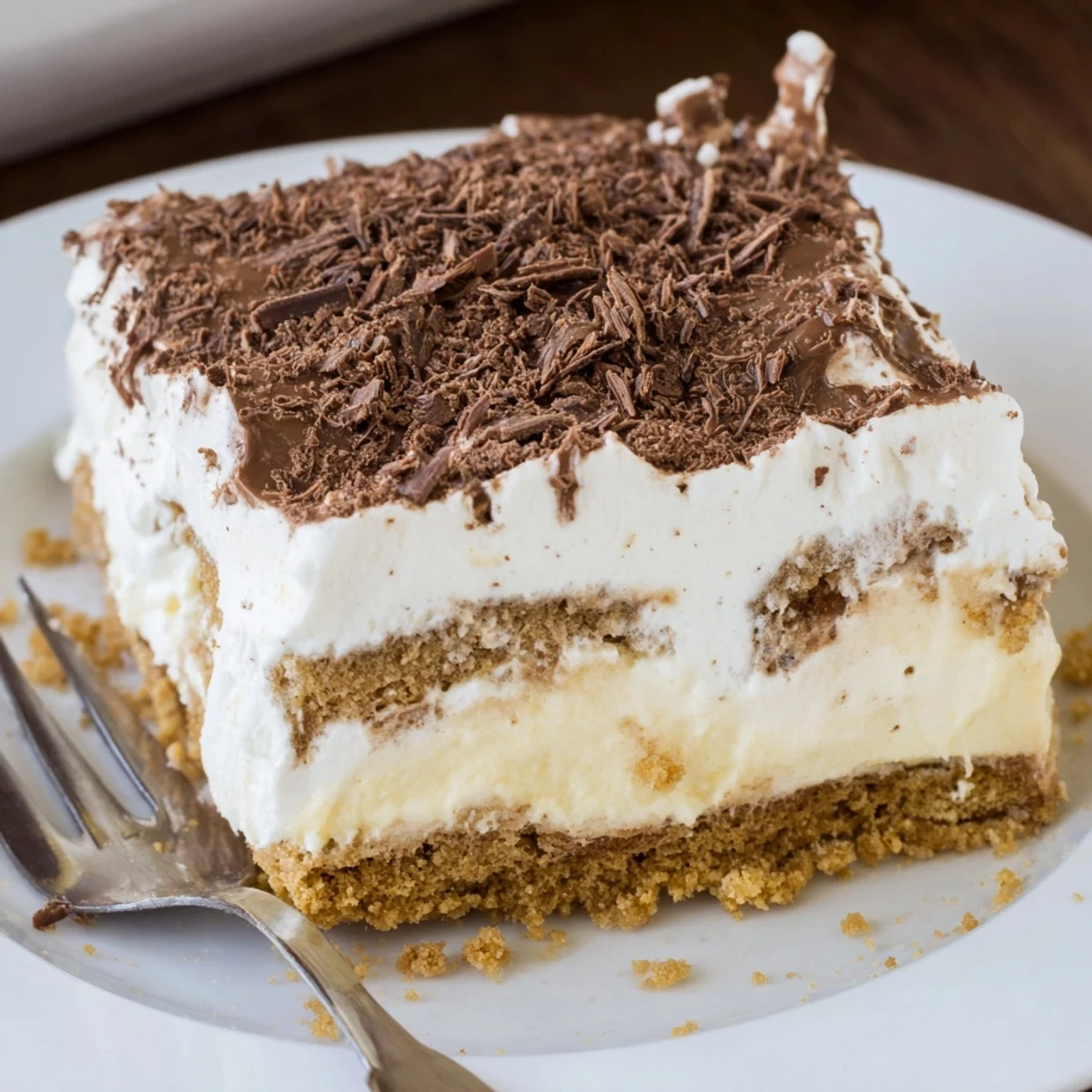 Slices of No Bake Layered Dessert showing cookie base and chocolate shavings