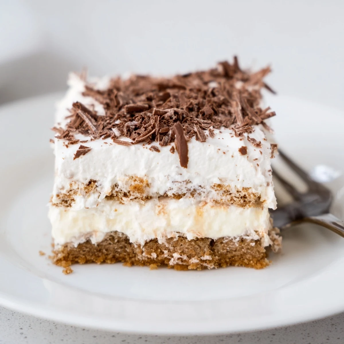 Served slice of No Bake Layered Dessert with berries, smooth cream layers