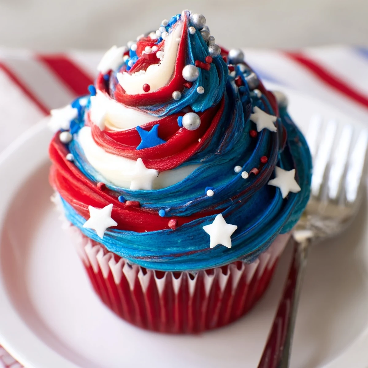 Patriotic Firework Cupcakes with bright red, white, and blue buttercream swirls