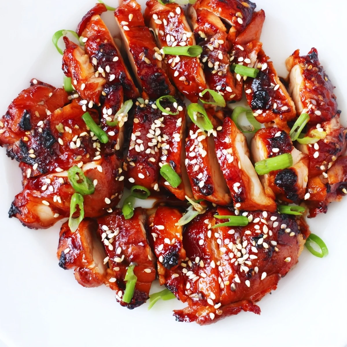 Juicy Chinese-style authentic char siu chicken sliced to reveal tender meat with glossy reddish-brown char siu glaze