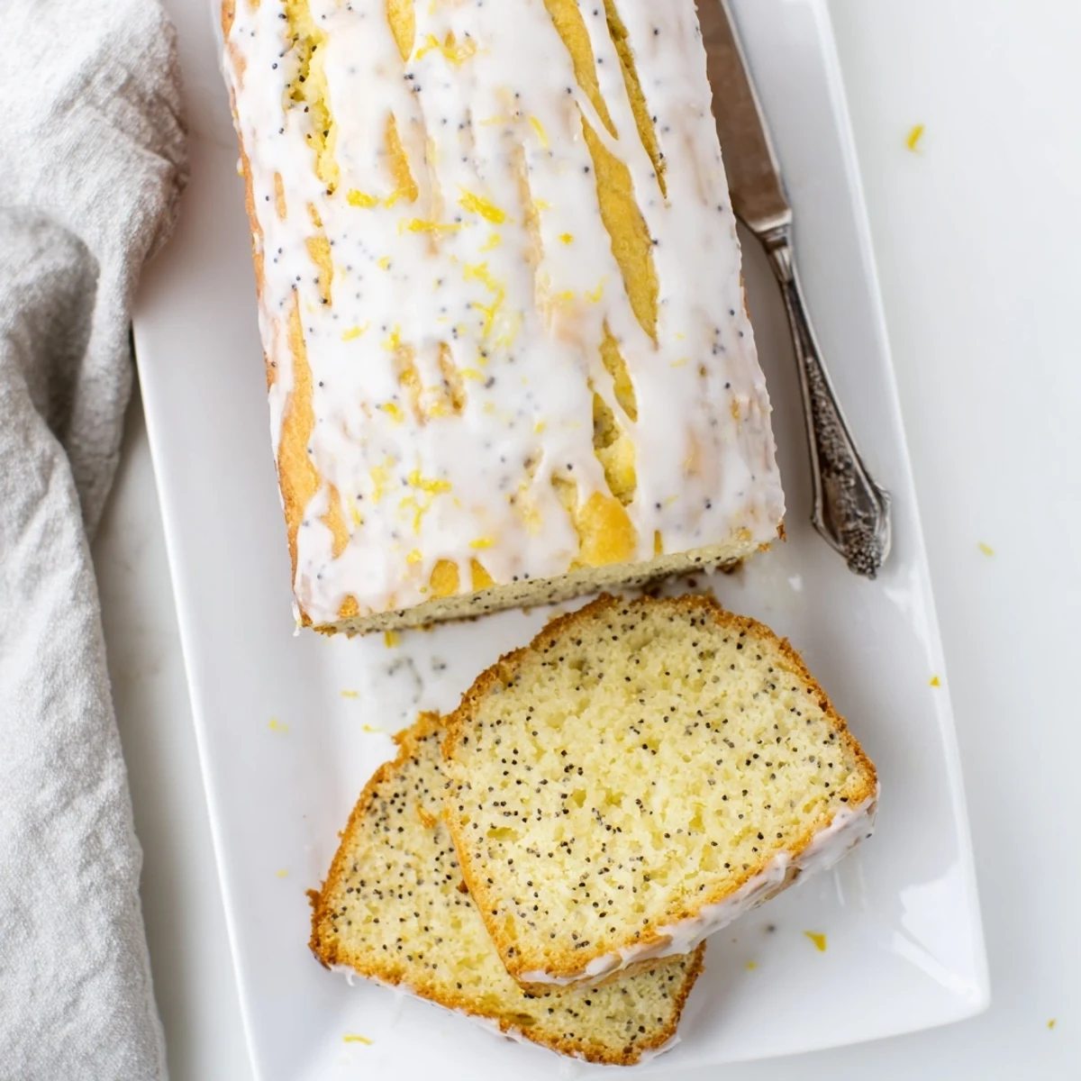 Vibrant lemon poppy seed dessert cooling on wire rack with citrus zest garnish