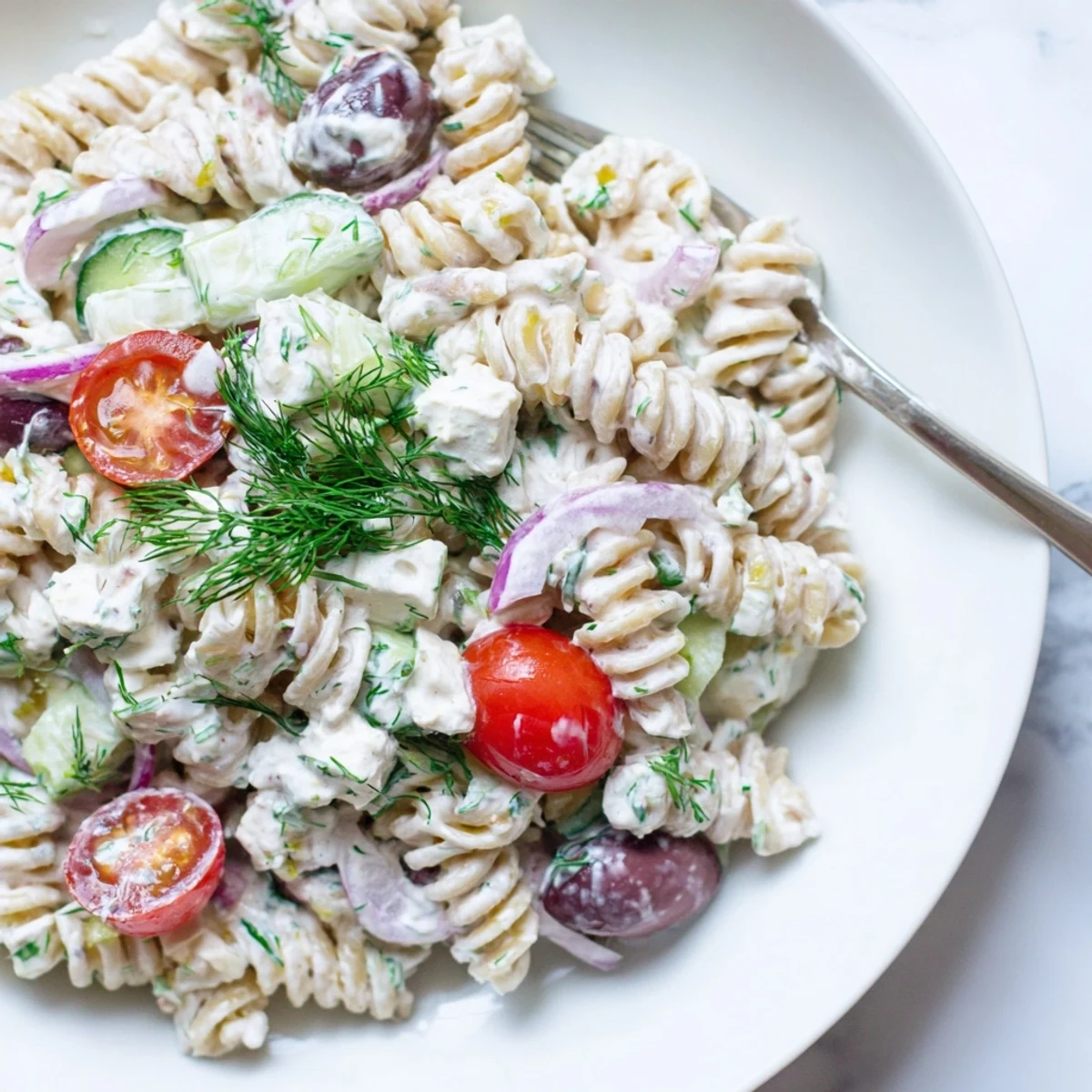 Quick Tzatziki Pasta Salad Mix served chilled for summer picnics, mint garnish.