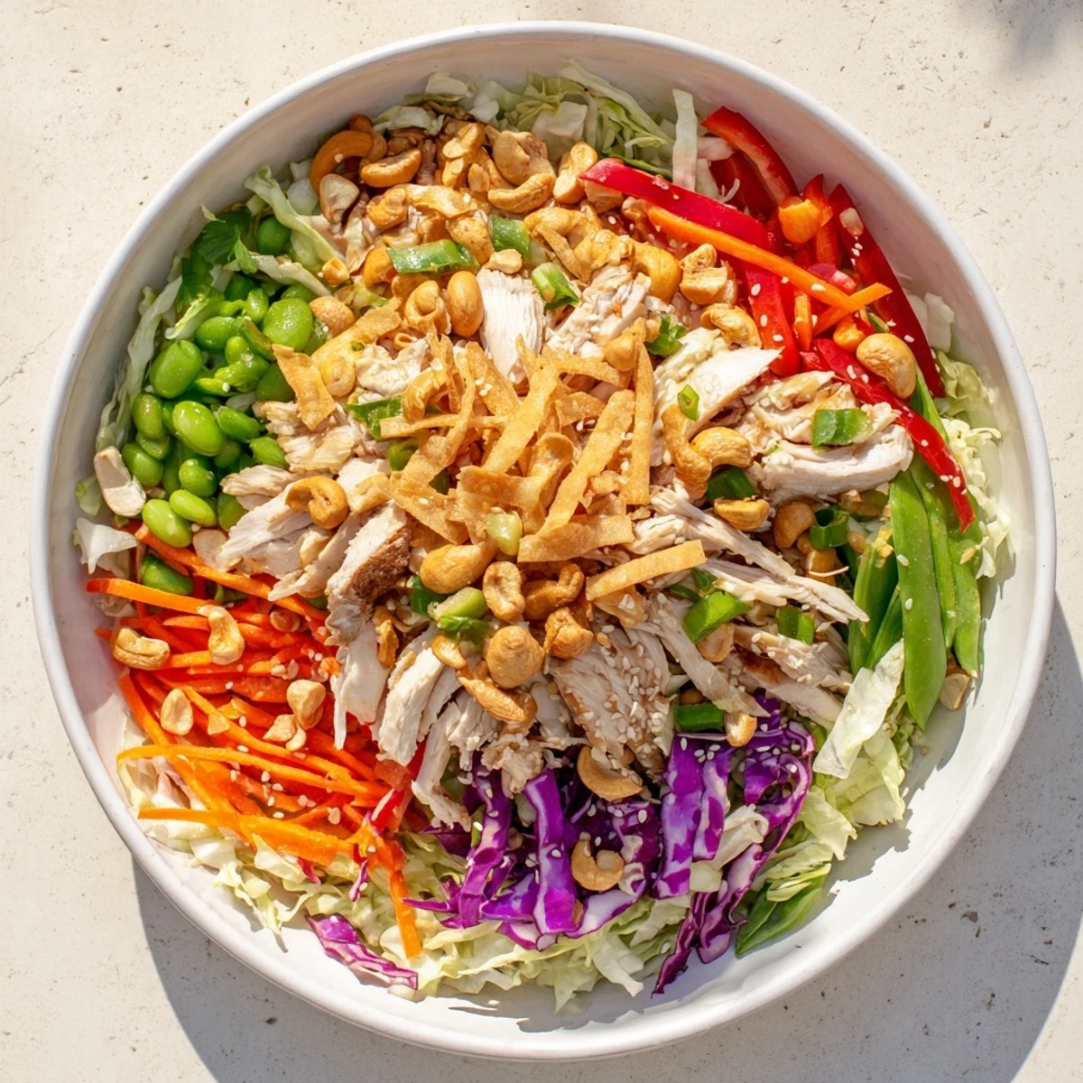 Golden sliced chicken over crisp cabbage in this chicken cashew crunch salad