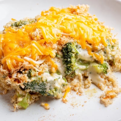 Tender broccoli and fluffy quinoa in a rich cheesy sauce served family-style for dinner
